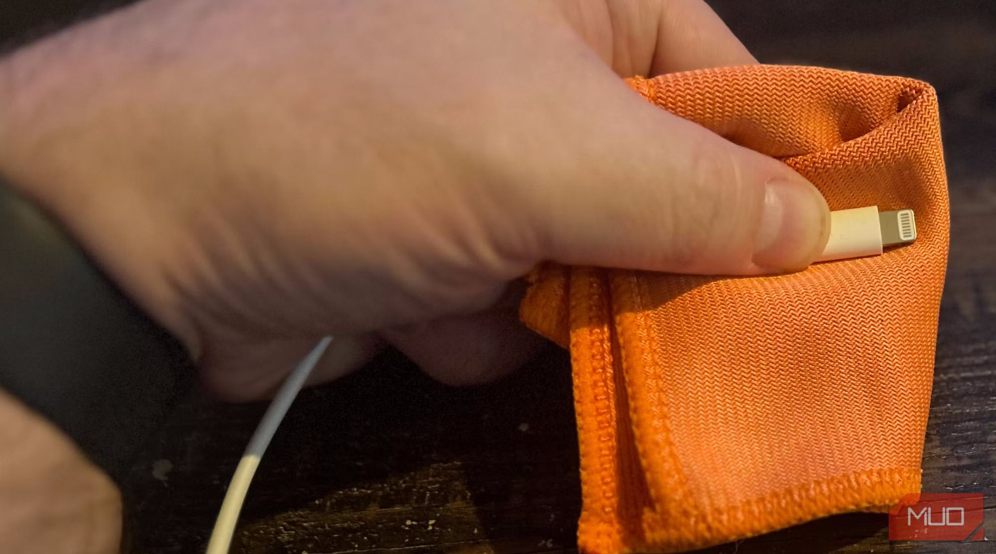 a person cleaning the Lightning connector