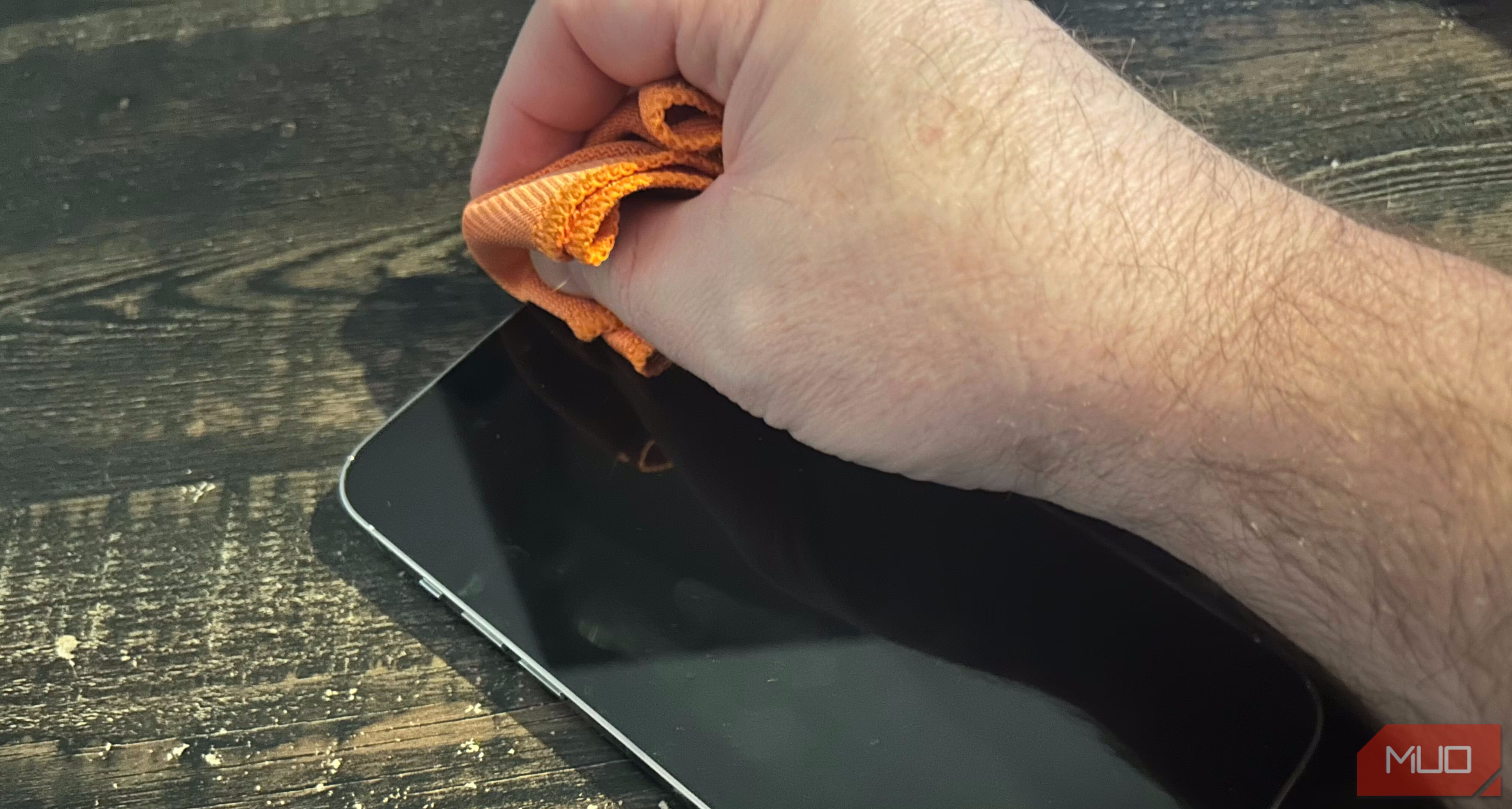 A person cleaning the sensor arrays of an iPhone